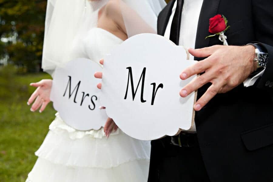 Bride and Groom holding signs "Mr." and "Mrs." answers the question "Will I Ever Find Love Again?"