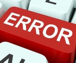Close up of a red "Error" button on a white keyboard.