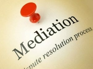 Yellow document with the word "Mediation" with a red thumb tack above it.