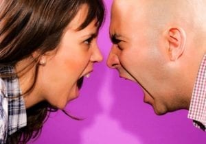 Angry couple screaming in each other's faces.