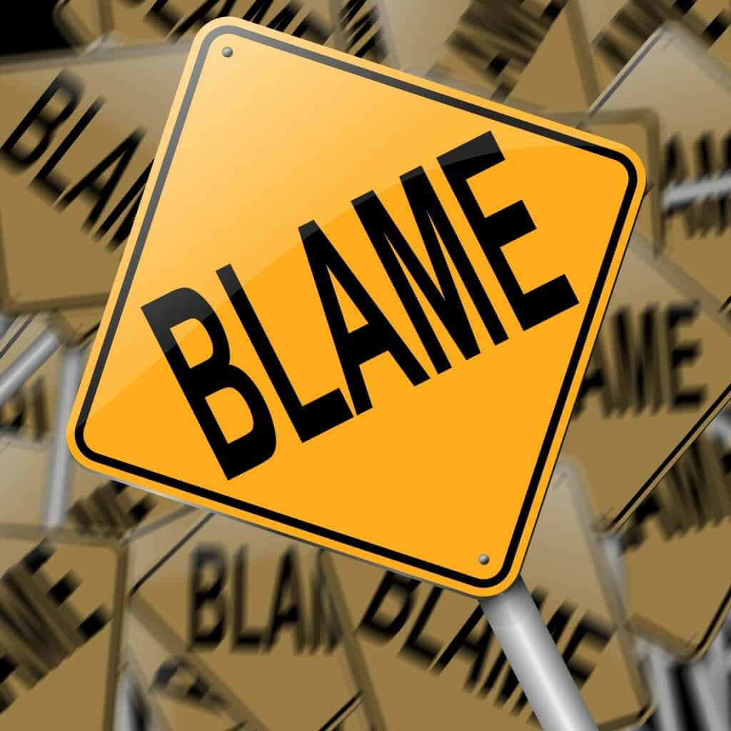 Yellow "Blame" sign with many similar signs in the background.