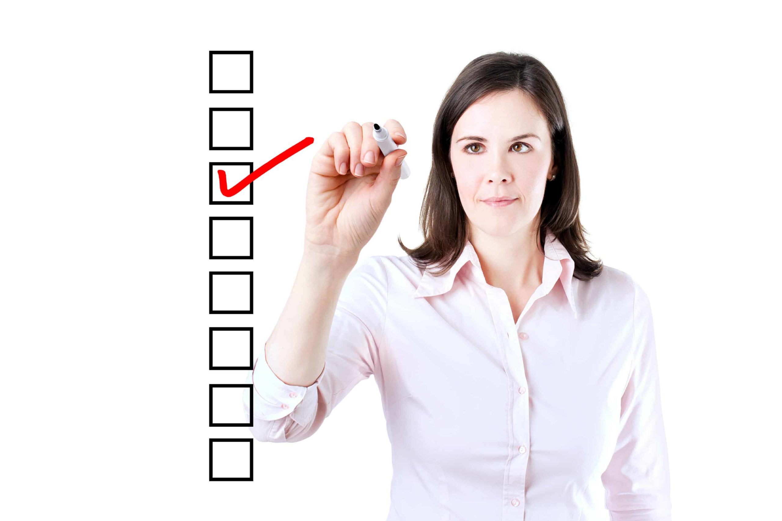 Woman checking box on a list.