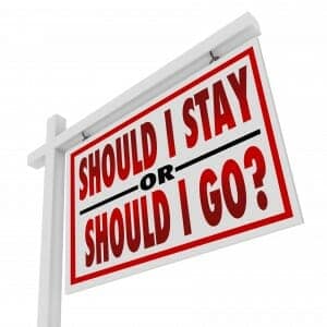 Home for sale sign stating, "Should I Stay or Should I Go?"
