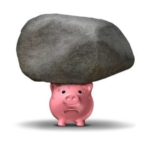 Sweating pink piggy bank with a big rock on it.