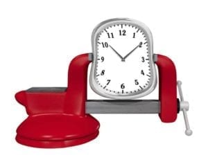 White clock squeezed in a red vice.