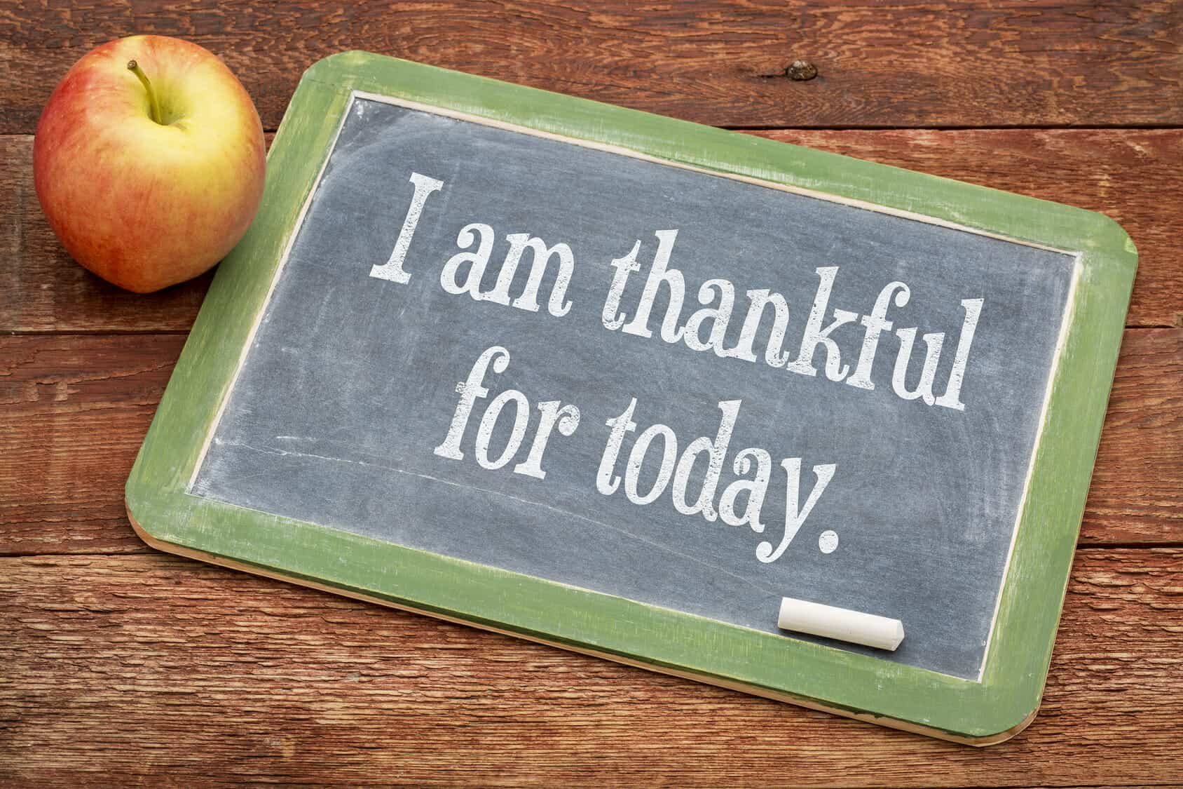 I am thankful for today - positive words on a slate blackboard against red barn wood