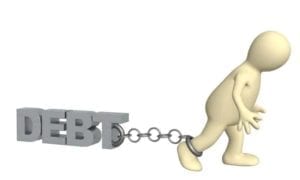 Figure of a man chained to a 3D word "Debt"