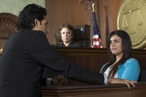 Courtroom scene where female witness testifies while a lawyer questions her and a judge looks on.