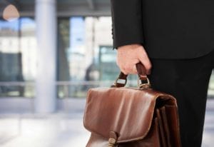 Close up of an old briefcase being carried by a lawyer.