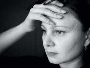Depressed woman holding her head, thinking, "I don't want to get divorced."