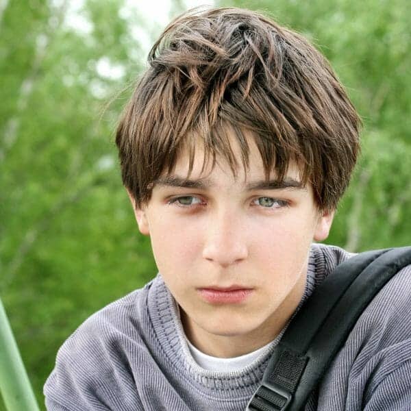 Children and divorce - unhappy young boy contemplating his parents' divorce