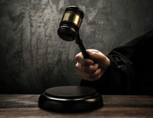 Close up of a divorce judge's hand banging a gavel in a DIY divorce.