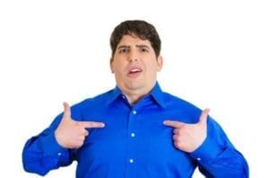 Man i a blue shirt pointing at himself doesn't believe you have to manage yourself