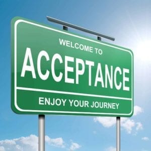 Green road sign that says "Welcome to Acceptance, Enjoy the Journey"
