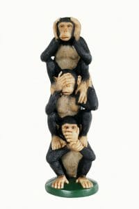 3 Monkeys stacked on top of each other signifying denial: see no evil, hear no evil, speak no evil