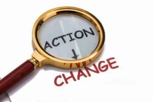 Magnifying Glass over the word action with an arrow to change: Should you act to change attorneys during divorce?
