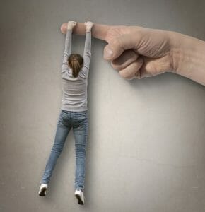 Giant hand with woman hanging on to a finger. She doesn't know how to let go.