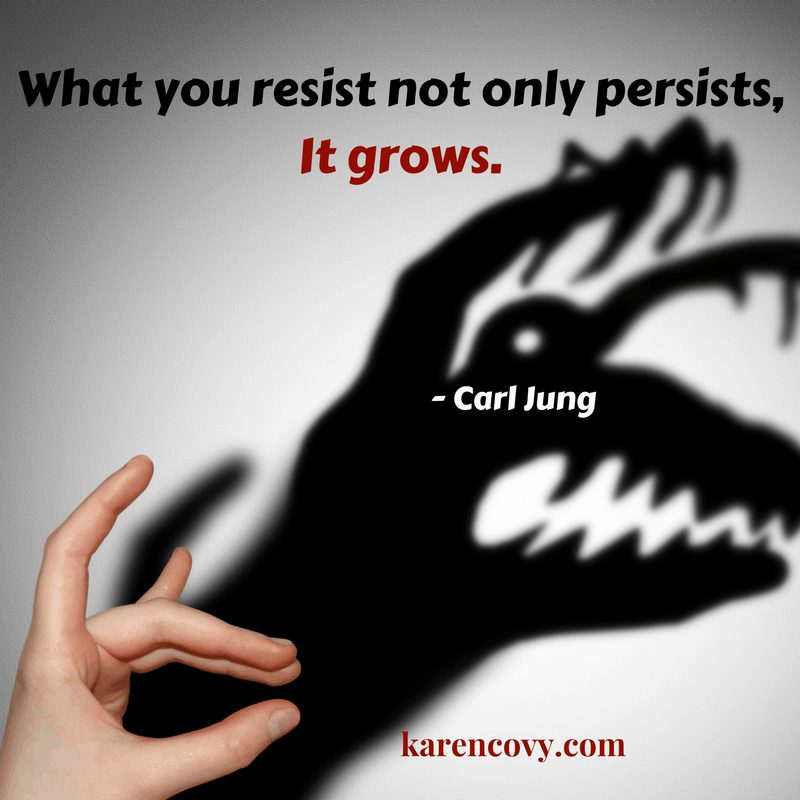 Shadow puppet of a hand making a monster shadow with the words, "What you resist not only persists, it expands," Carl Jung.