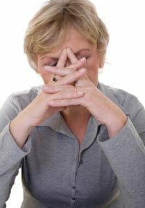 Upset woman with her hands over her face