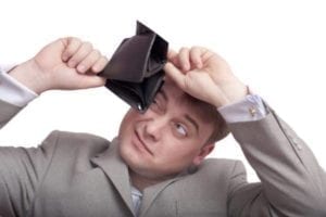 Man peering into empty wallet wondering if alimony is tax deductible