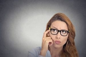 Woman with glasses thinking and preparing for divorce mediation