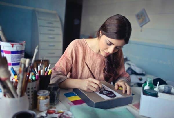 Young woman painting a picture