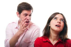 Couple arguing over a parenting plan. Man screaming. Woman rolling her eyes.