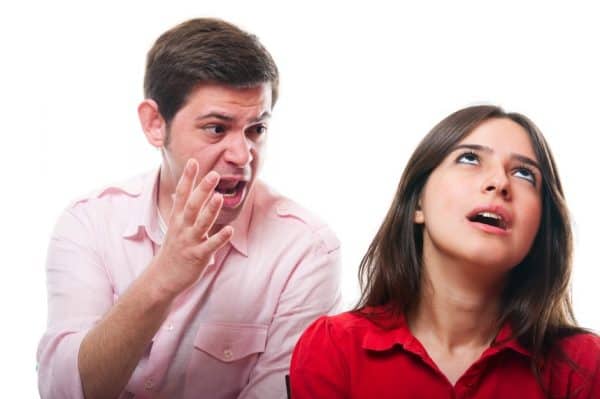 Couple arguing over a parenting plan. Man screaming. Woman rolling her eyes.