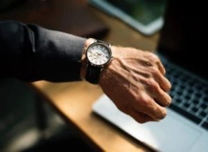 CLose up of a male hand showing watch. Why does divorce take so long?