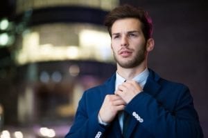 Handsome young man in a business suit demonstrating what to wear to court.