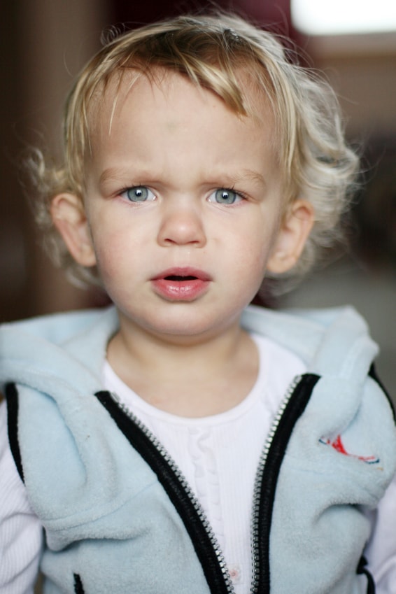 Cute young boy looking confused.