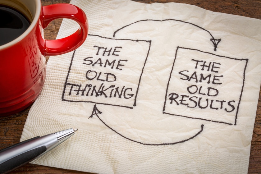 Red coffee cup next to napkin with the words "The same old thinking" linked to "The same old results."
