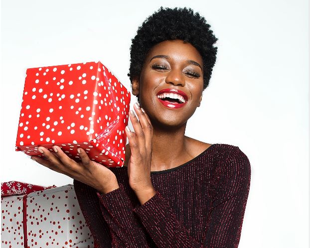 Smiling African American Woman holding a gift