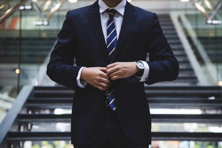 Close up of a male divorce lawyer in a navy blue suit.