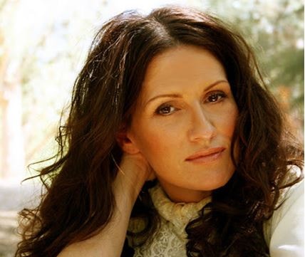 Picture of beautiful brunette woman loking into camera.