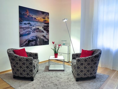 Modern, clean room with 2 chairs and a picture on the wall. Take control of your environment.