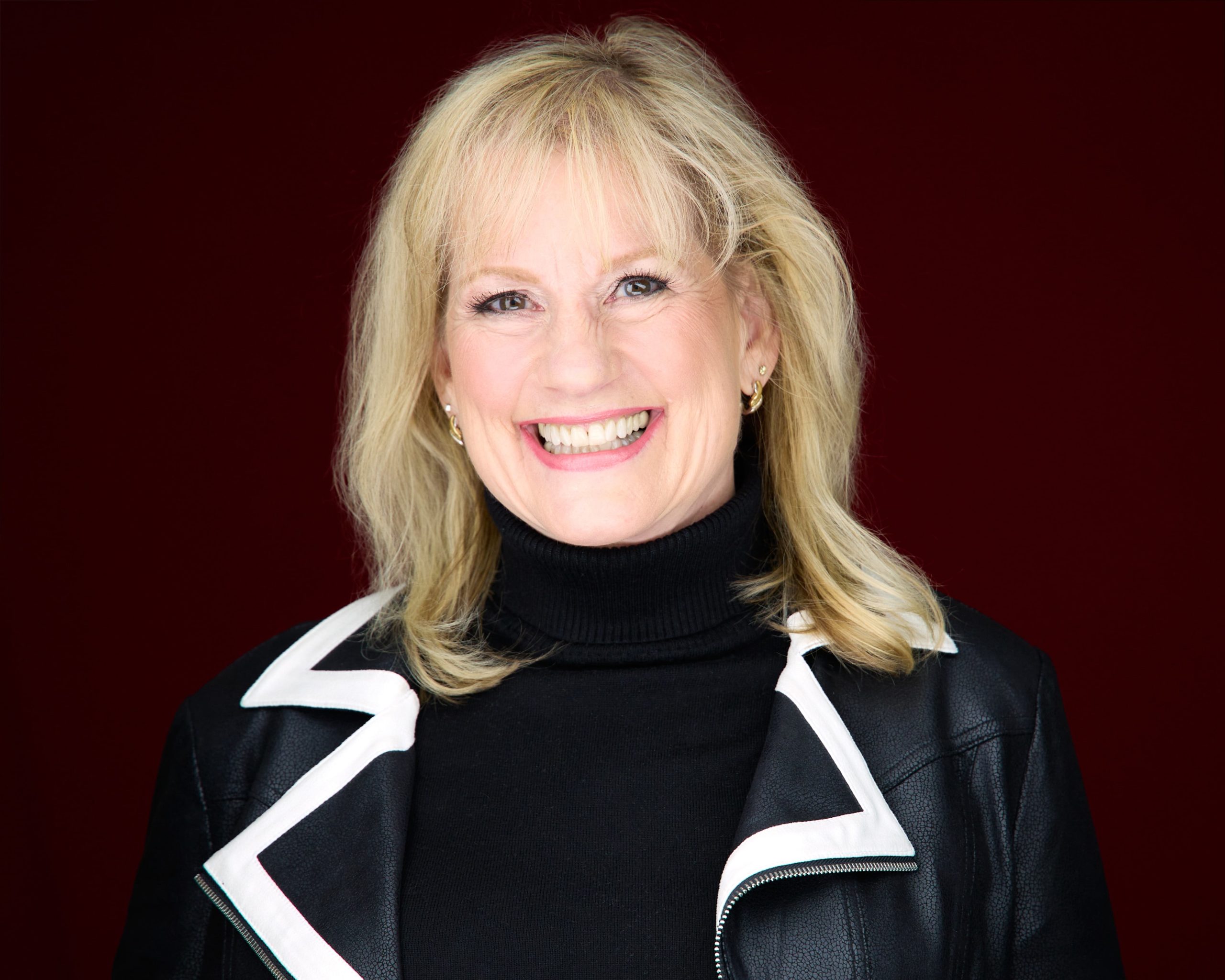 Karen Covy in a black jacket with white trim.