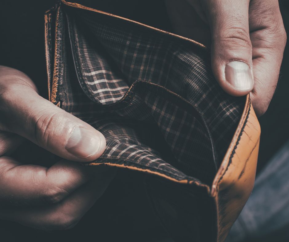 Hands holding an empty wallet signifying "No money."